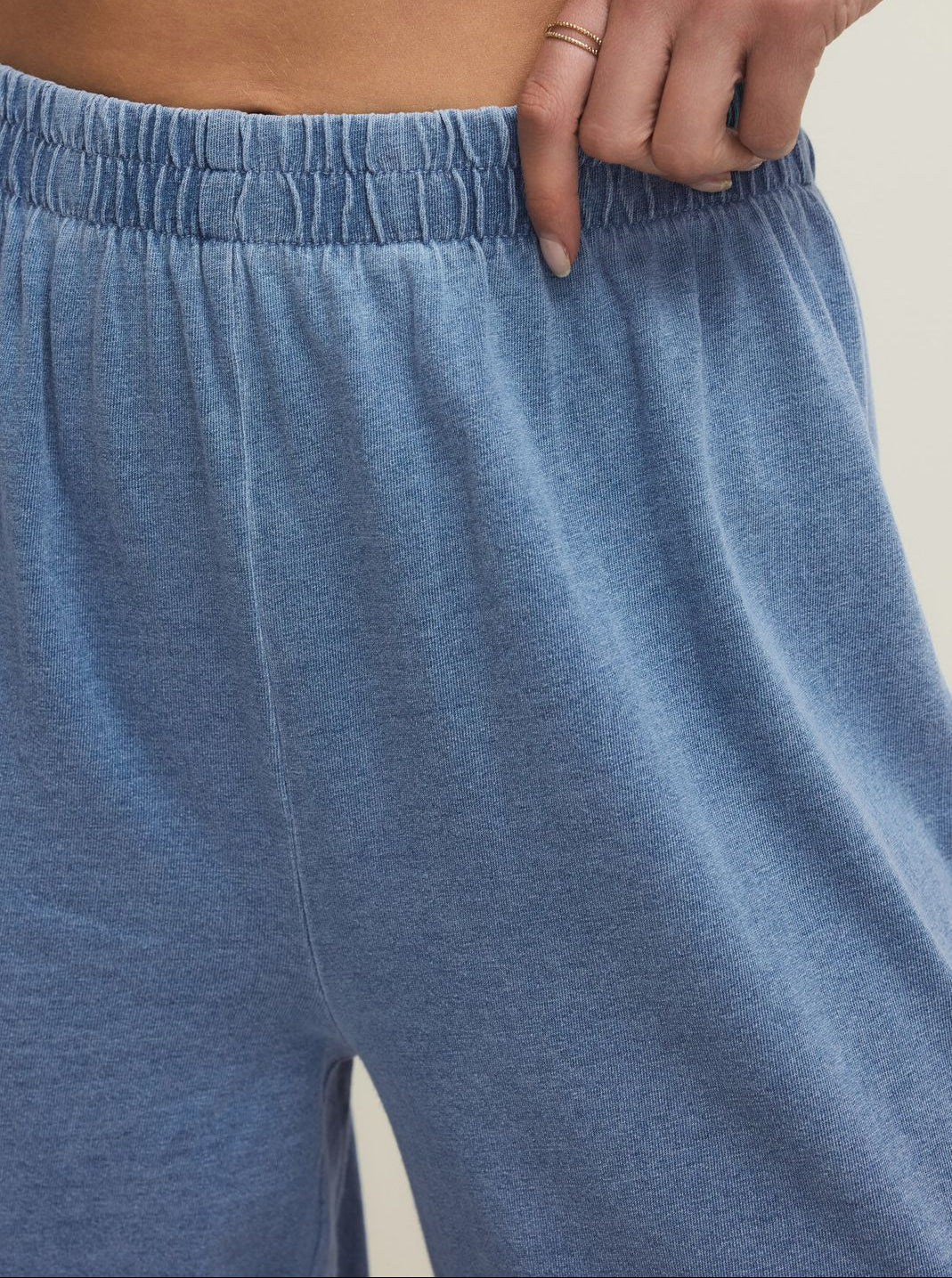 Blue pajama pants worn by a person with a neutral background