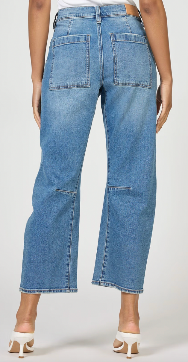 Blue jeans worn by a person on a white background