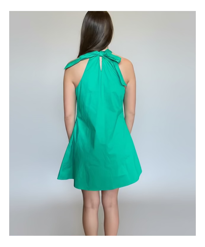 Green dress worn by a person on a plain background