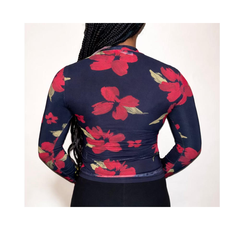 Navy long-sleeve top with red floral pattern worn by a person on a white background