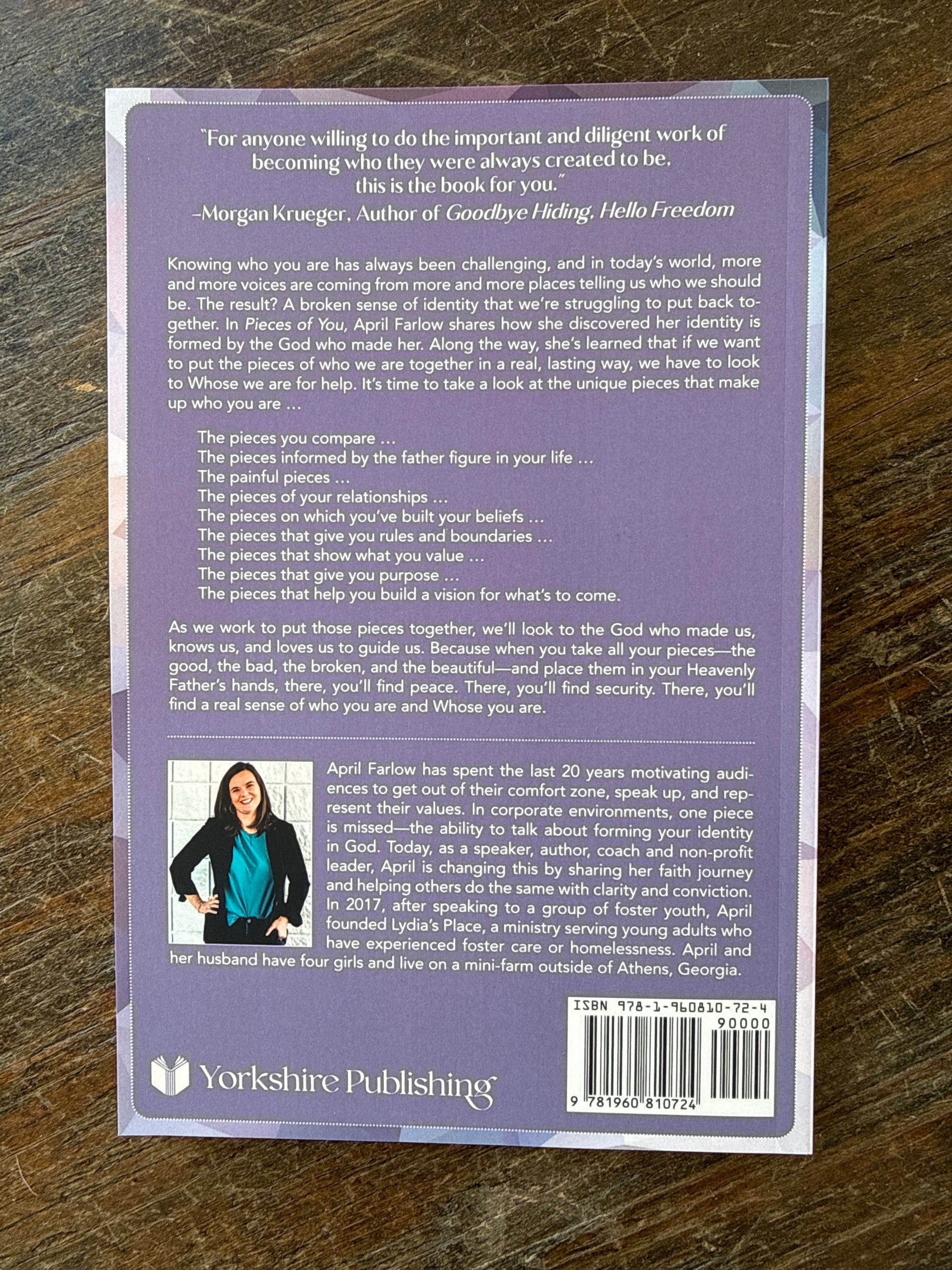 Back cover of a book with text and a barcode on a wooden surface