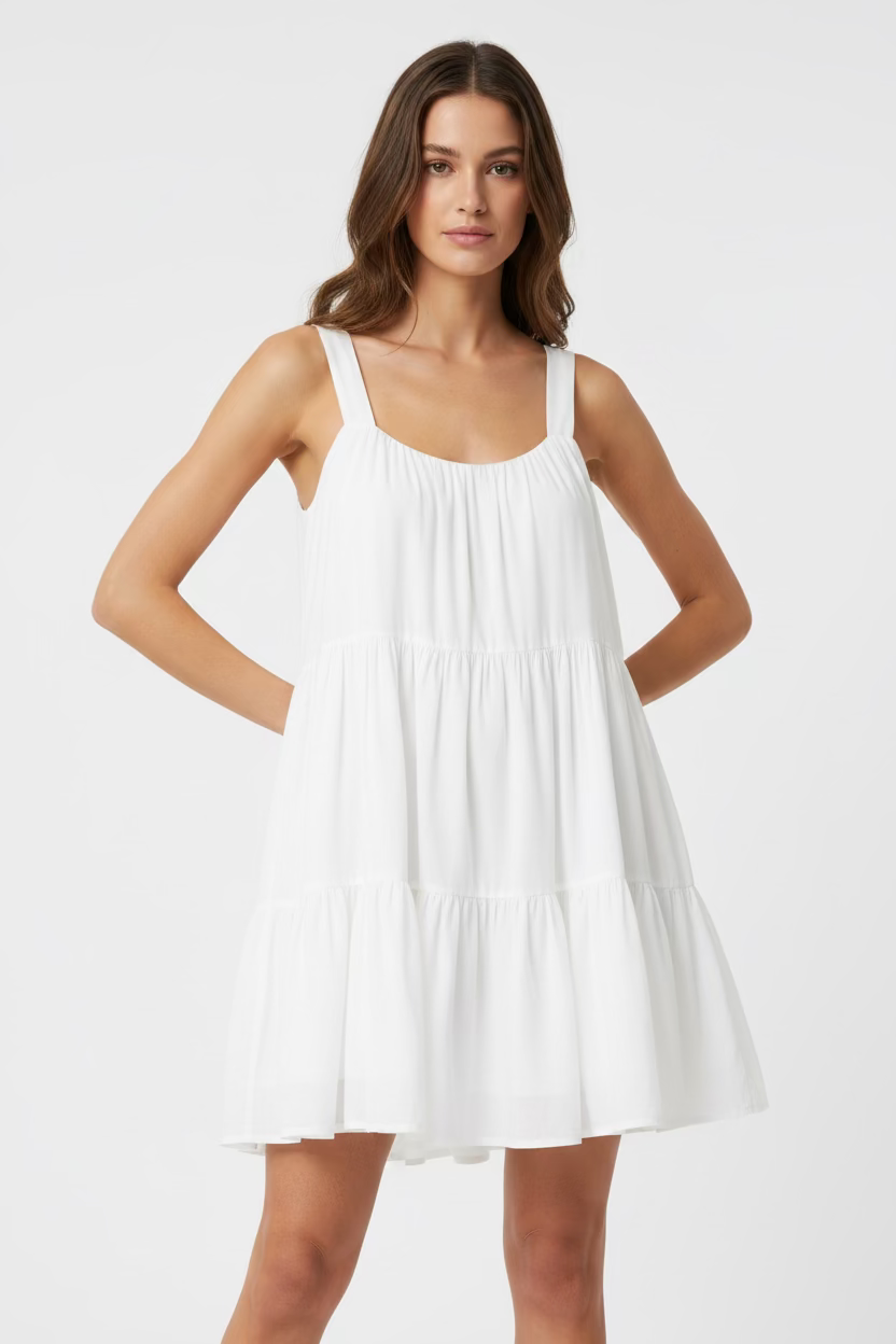 Woman wearing a white dress against a white background