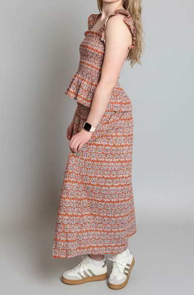 Woman in a patterned shirt and skirt 