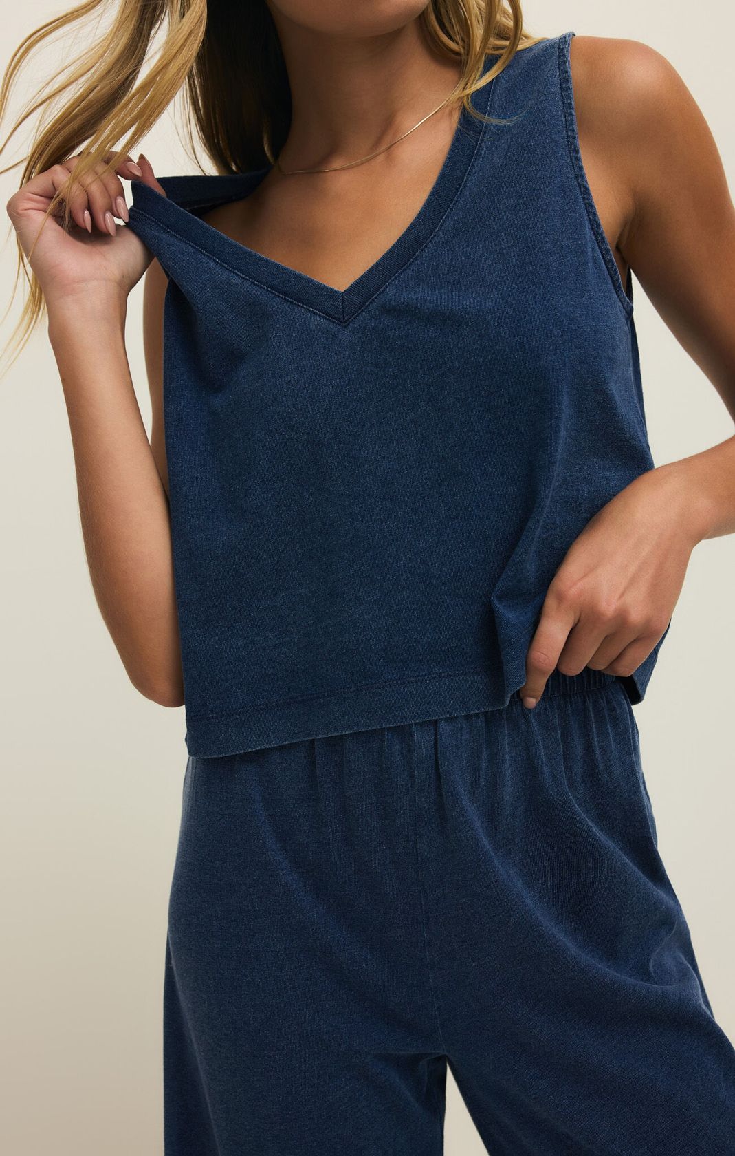 Navy blue sleeveless top and pants set on a neutral background