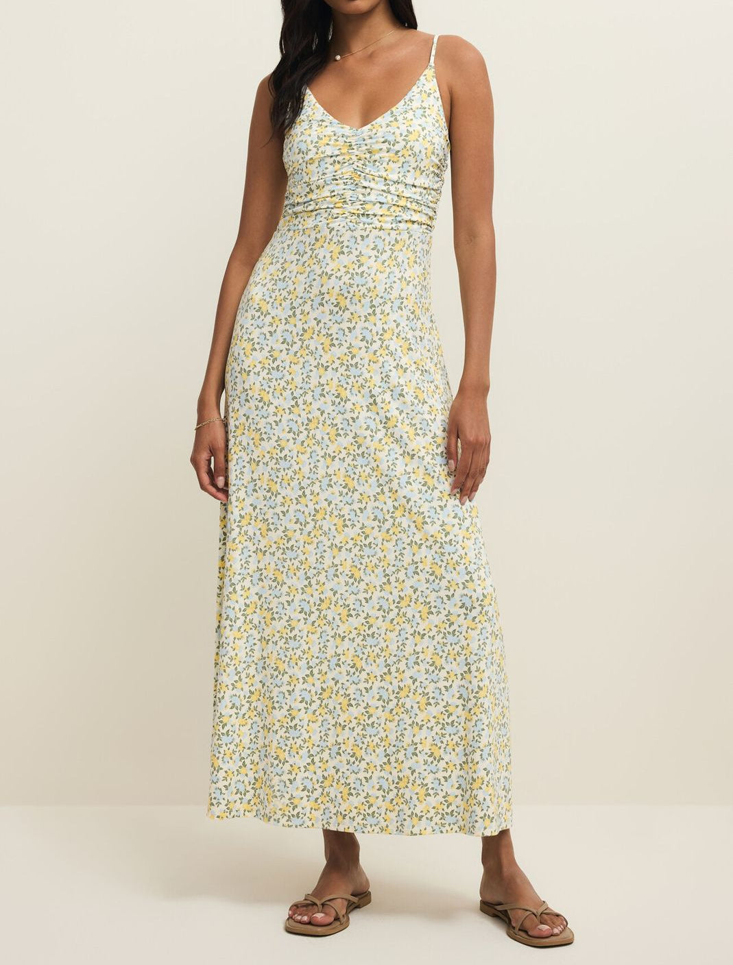 Woman wearing a floral dress on a plain background