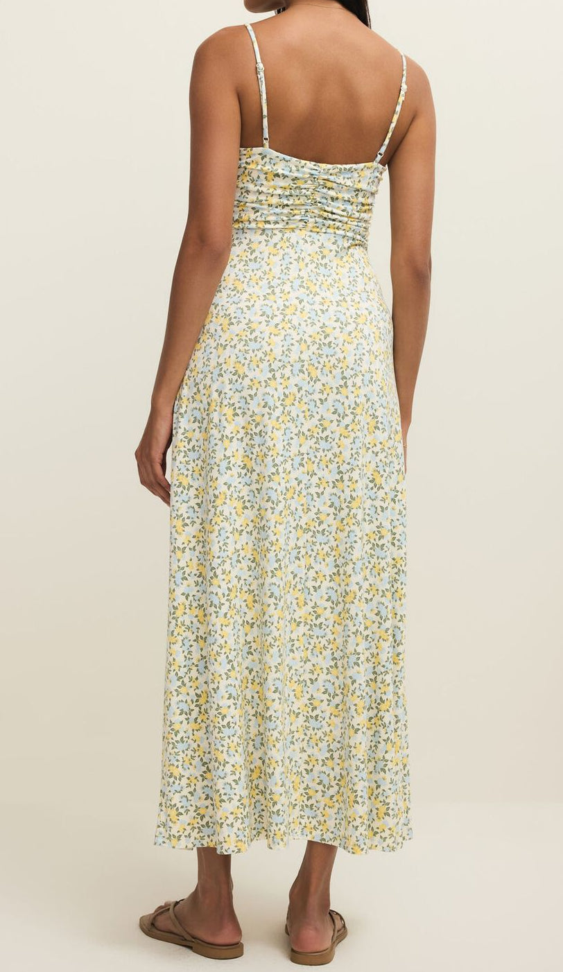 Woman wearing a floral dress on a plain background