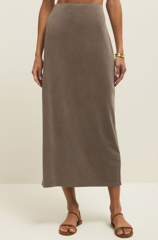 Person wearing a brown skirt on a plain background