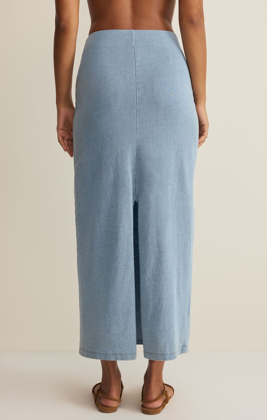 Light blue wide-leg pants worn by a person on a beige background