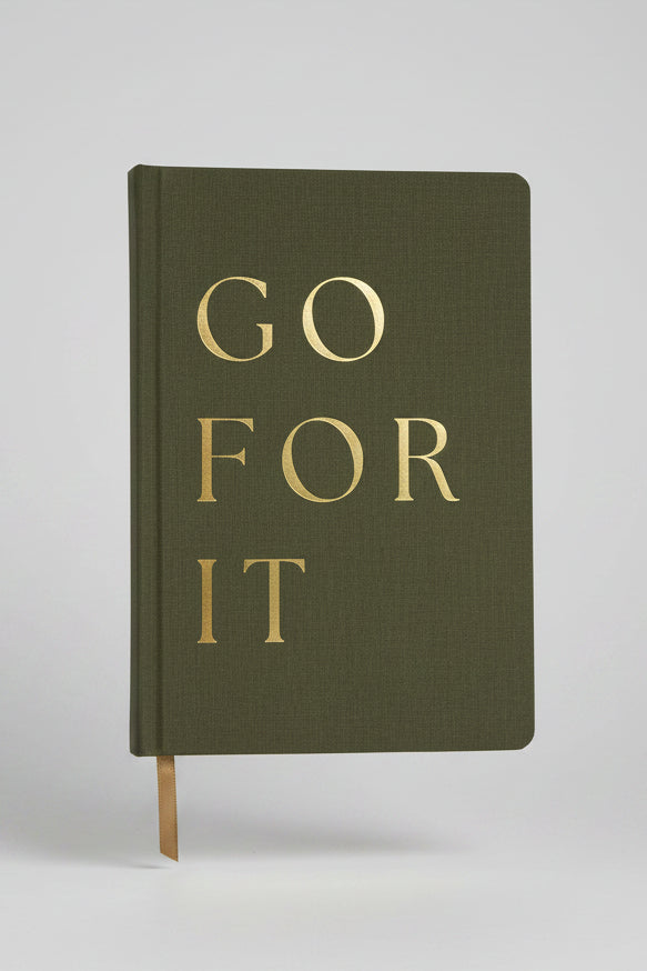 Green notebook with 'GO FOR IT' text on a white background