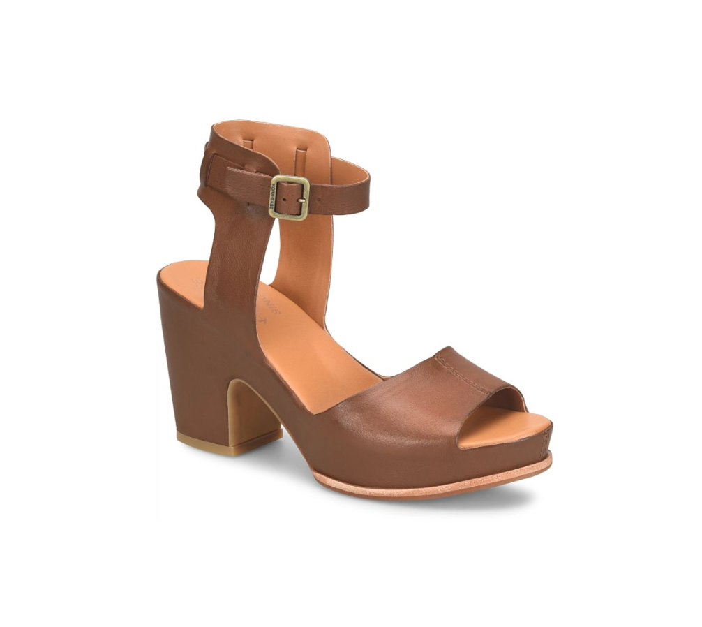 A brown ankle-strap sandal with a buckle closure and chunky heel.