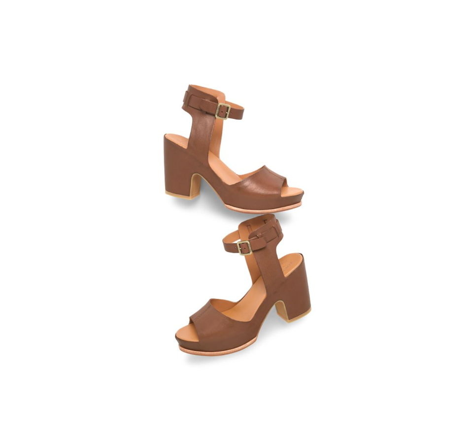 Pair of brown block-heeled sandals on a white background