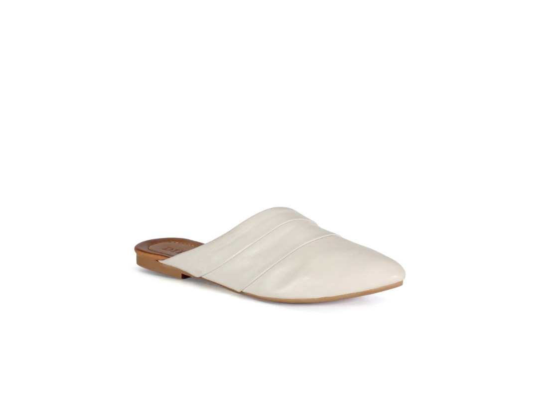White slip-on shoe with a brown sole on a white background
