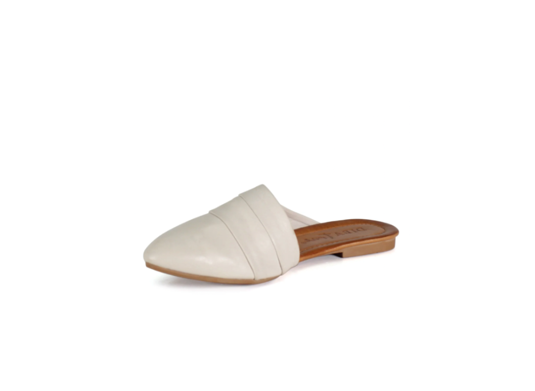 White slip-on shoe with a brown sole on a white background