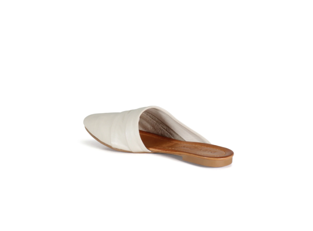 White slip-on shoe with a brown sole on a white background