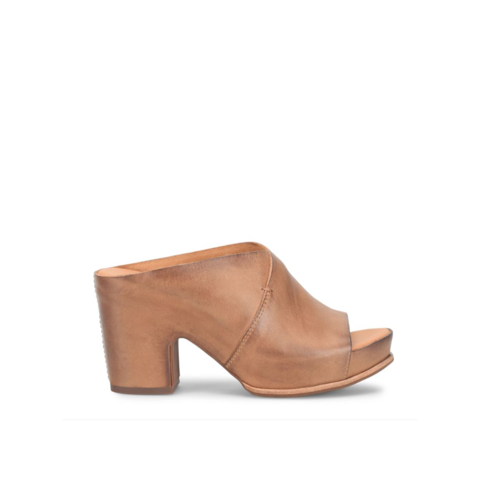 Brown leather mule shoe on a white background