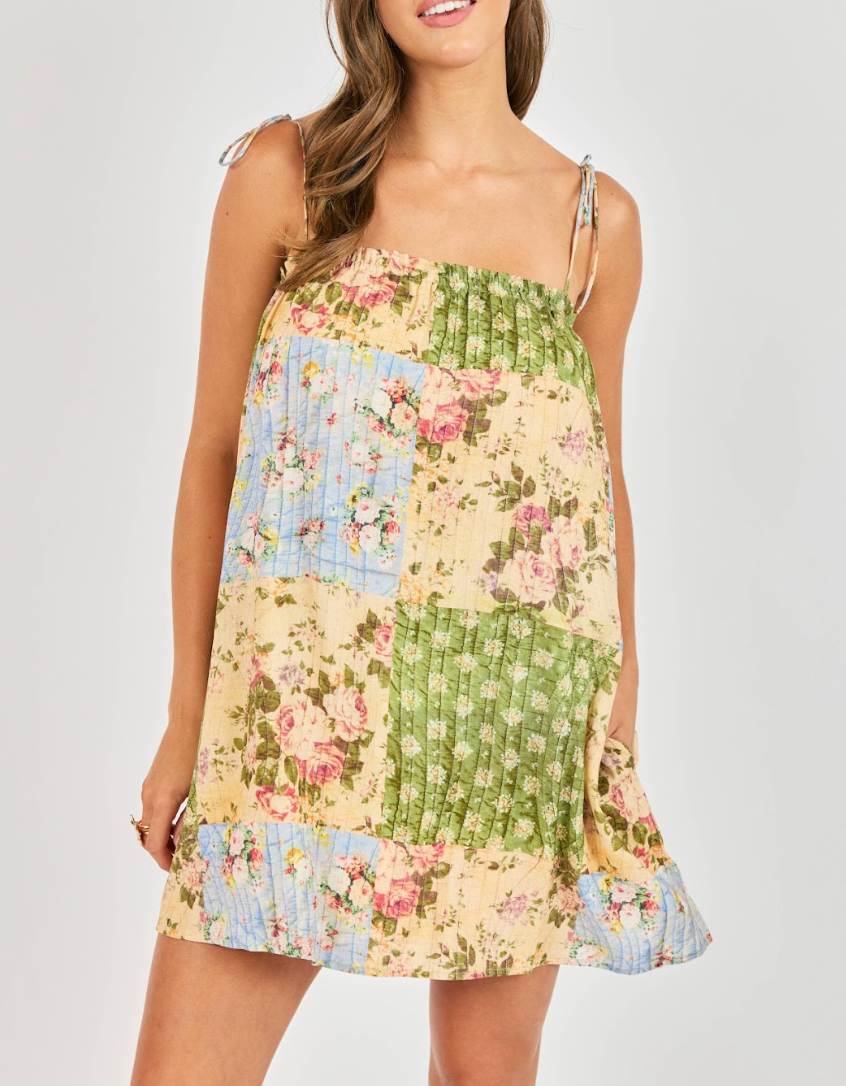 Floral patterned dress  against a white wall