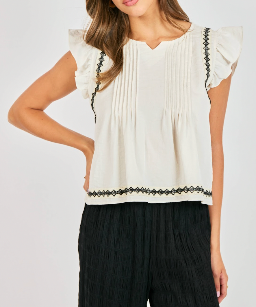 White blouse with black trim 