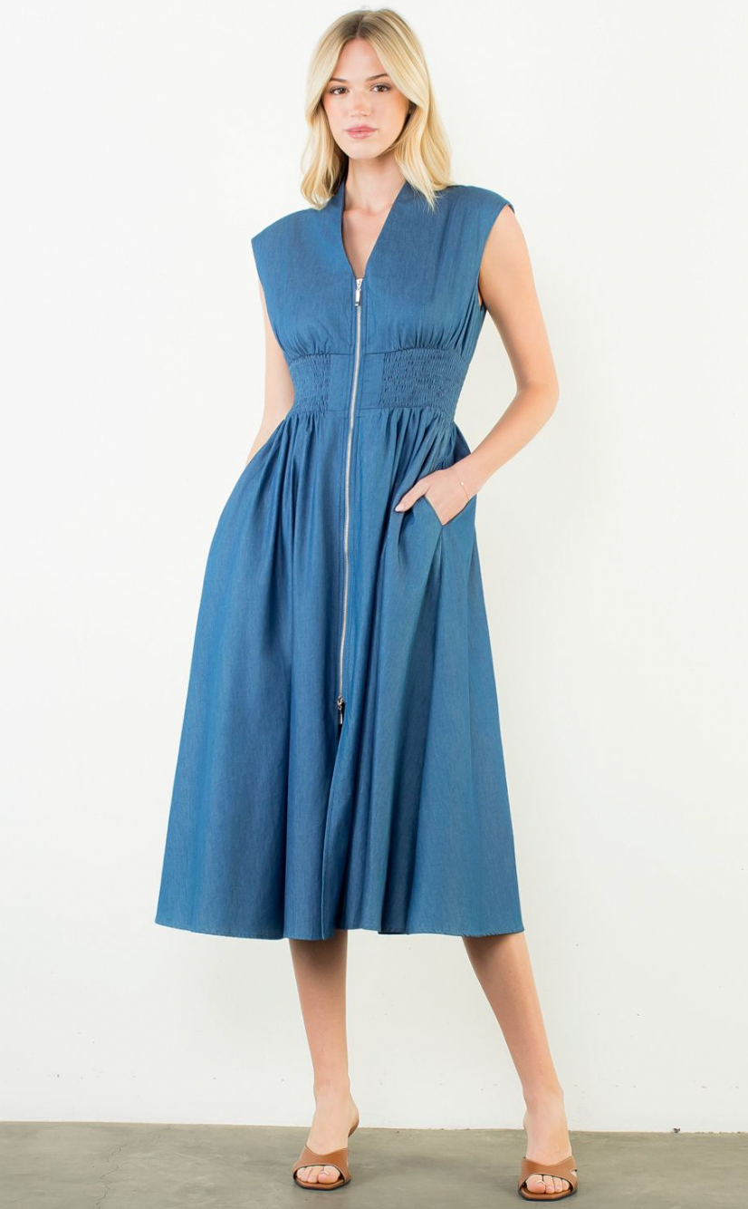 Woman wearing a blue dress with a white background