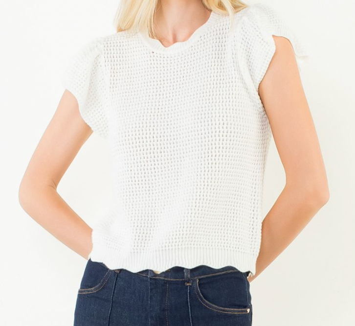 White sleeveless top worn by a person on a white background