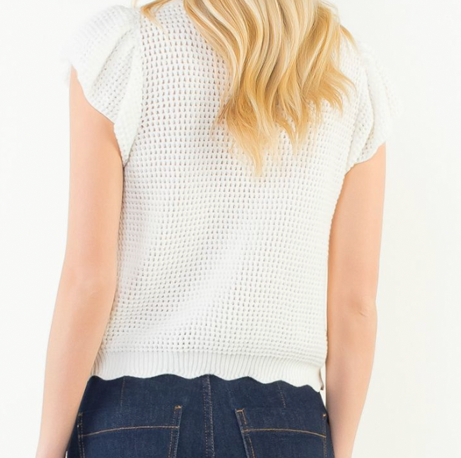 White textured sleeveless top worn by a person on a white background