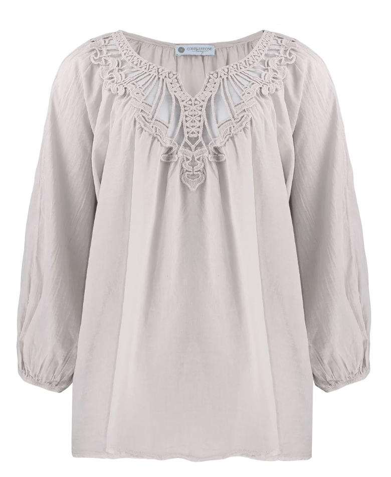 Light gray blouse with lace details on a white background