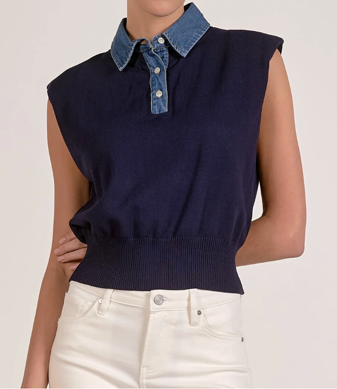 Navy sleeveless sweater with denim collar worn by a person on a plain background