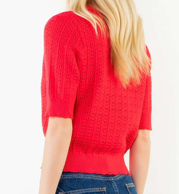 Red lace top worn by a person on a white background
