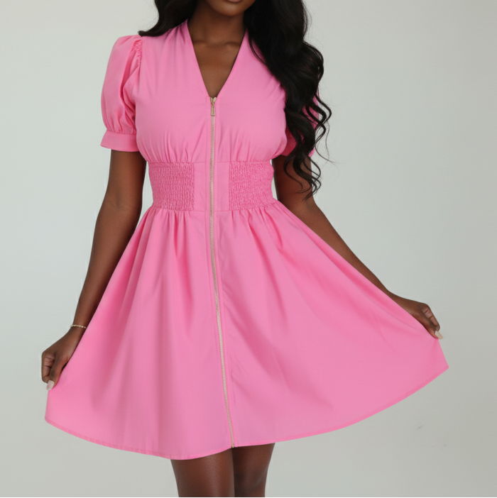 Pink dress with puff sleeves worn by a person on a white background