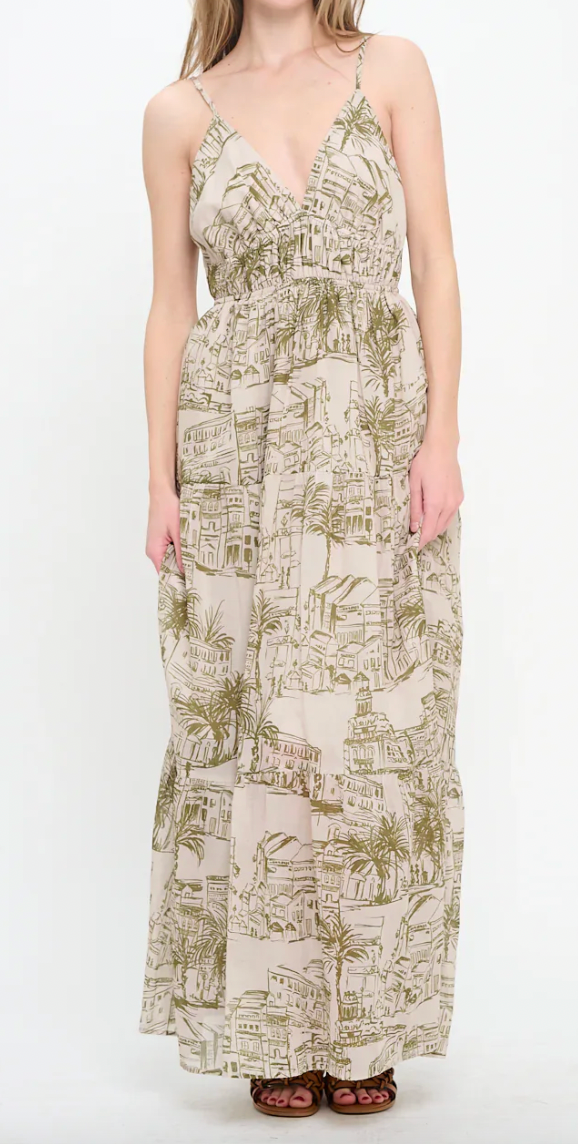 Woman wearing a long, patterned dress on a white background