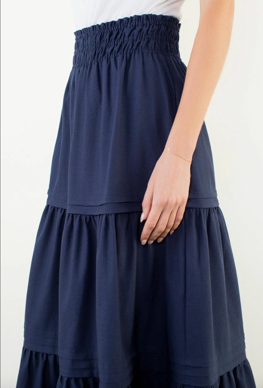 Navy blue skirt worn by a person on a white background