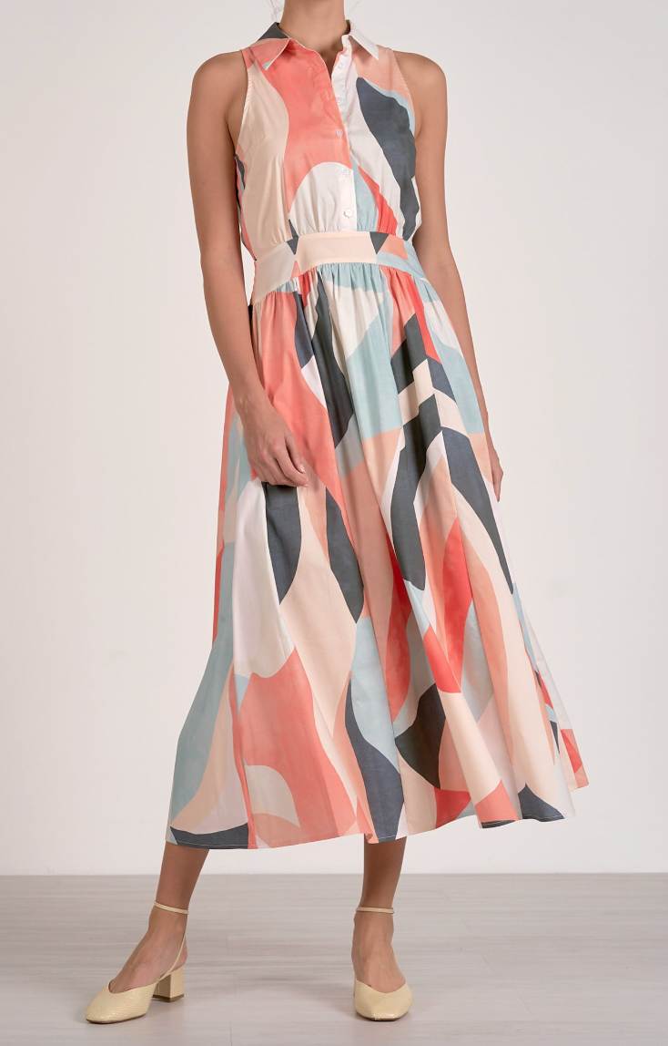 Colorful patterned dress worn by a person on a plain background