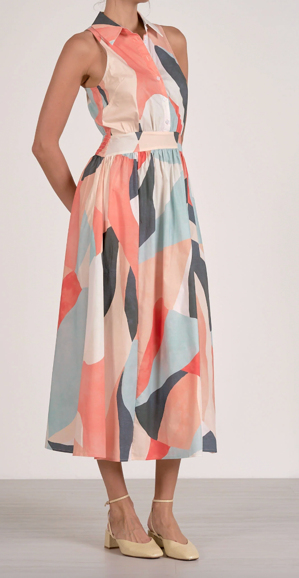 Colorful abstract patterned dress worn by a person on a white background