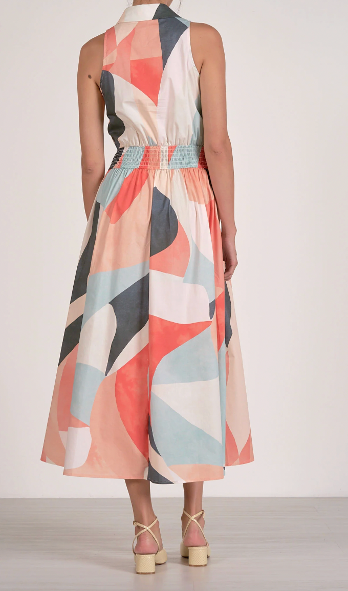 Woman wearing a sleeveless dress with a geometric pattern on a white background