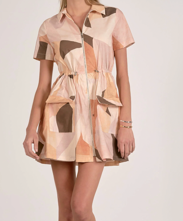 Woman wearing a patterned dress on a white background