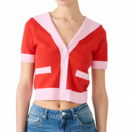 Red and pink cardigan worn by a person on a white background