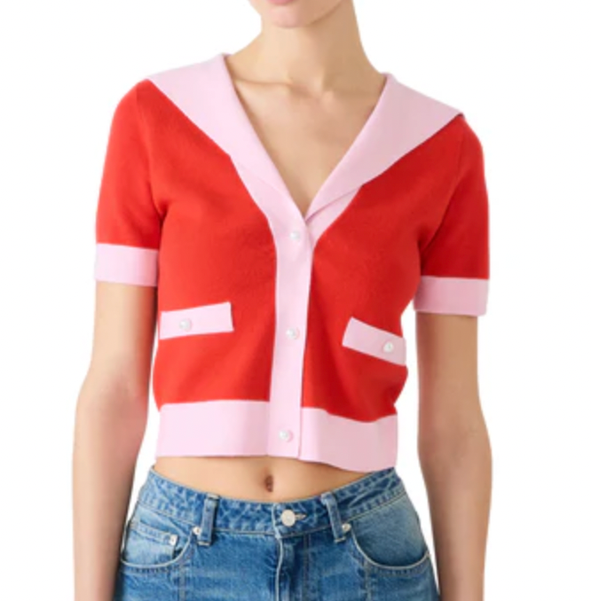 Red and pink cardigan worn by a person on a white background