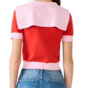 Red and pink top worn by a person on a white background