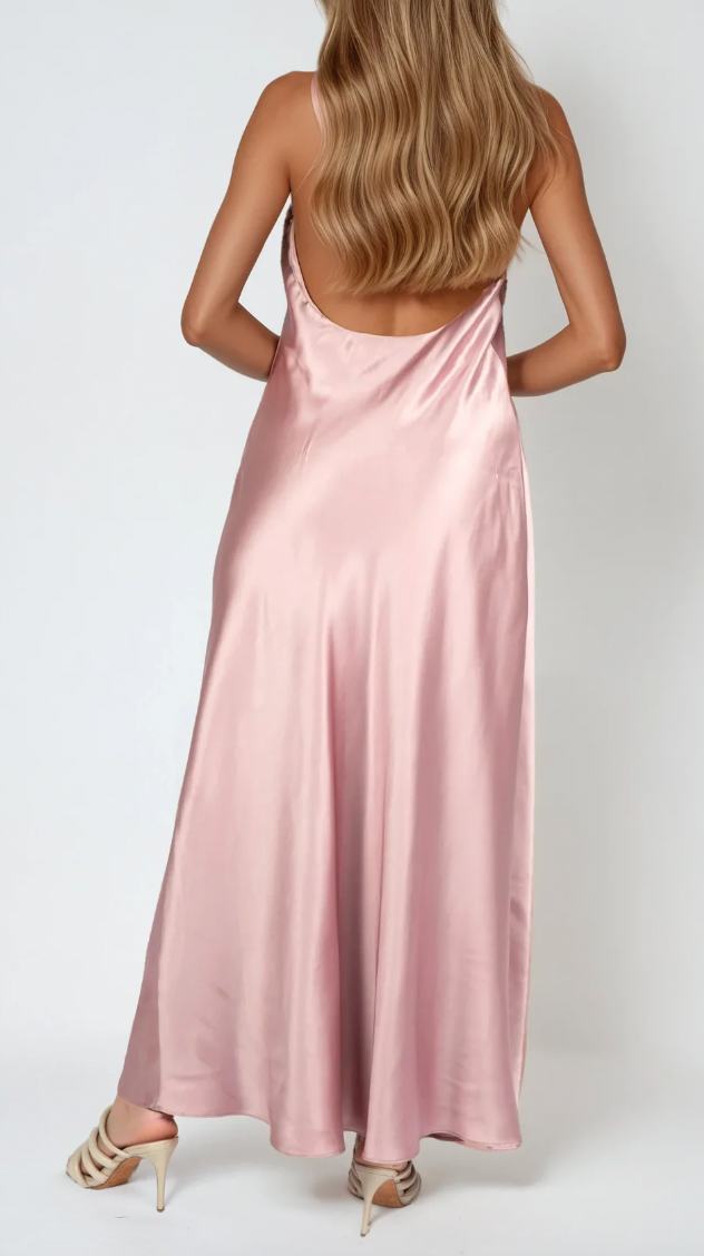 Pink satin slip dress worn by a person on a white background