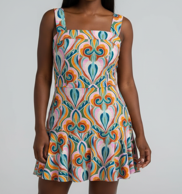 Woman wearing a colorful patterned dress indoors.