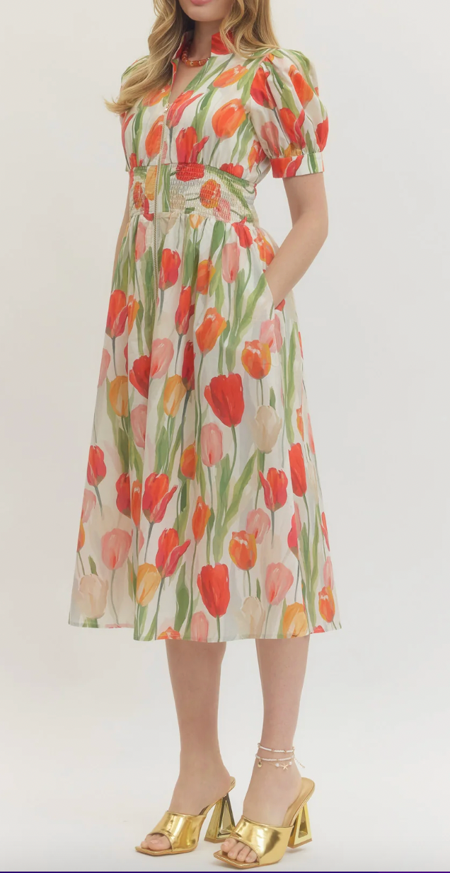 Woman wearing a floral dress with tulip pattern on a white background