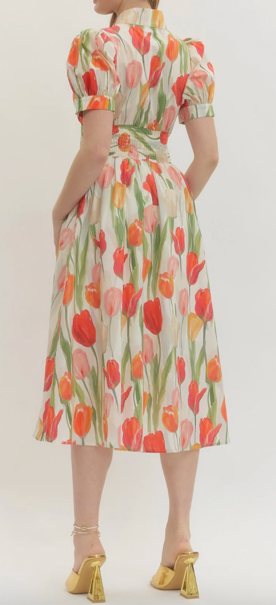 Woman wearing a floral dress with a plain background