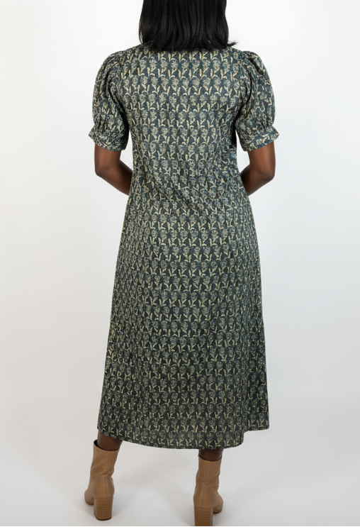 Person wearing a patterned dress on a white background