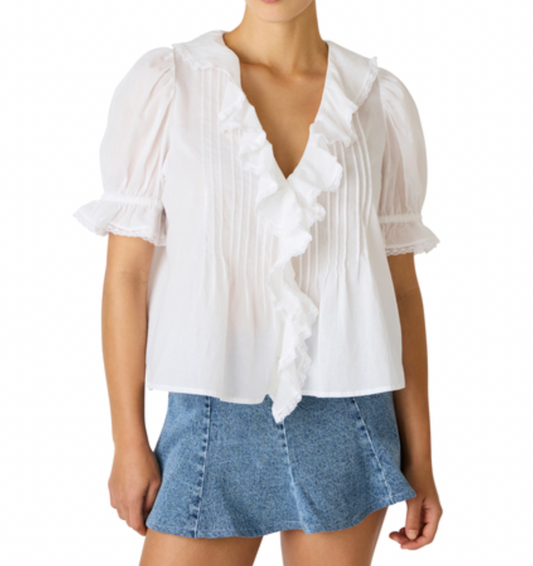 White blouse with ruffles and a denim skirt on a white background
