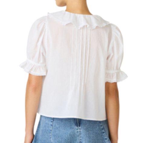 White blouse with ruffled details on a white background