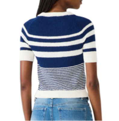Person wearing a blue and white striped sweater with a blurred background