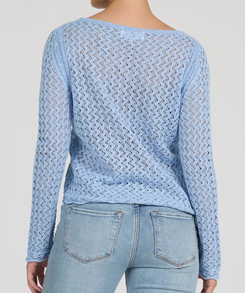 Light blue crochet top worn by a person on a plain background