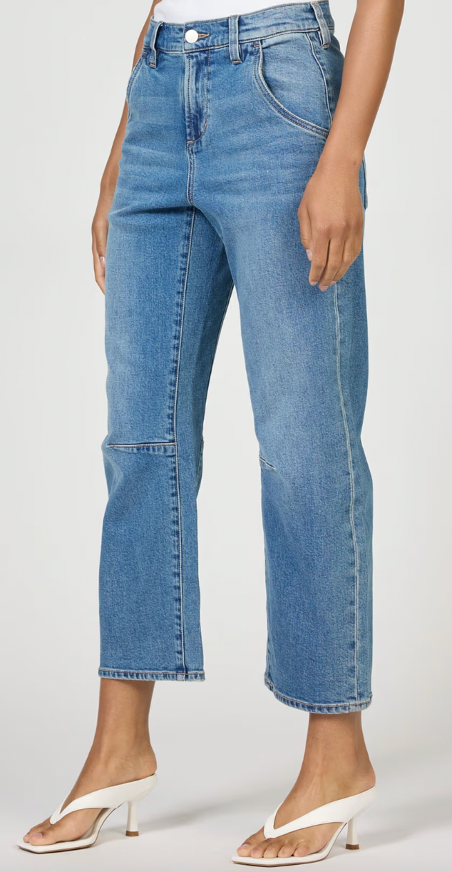 Person wearing blue jeans on a white background
