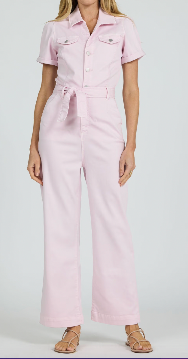 Person wearing a light pink jumpsuit on a white background