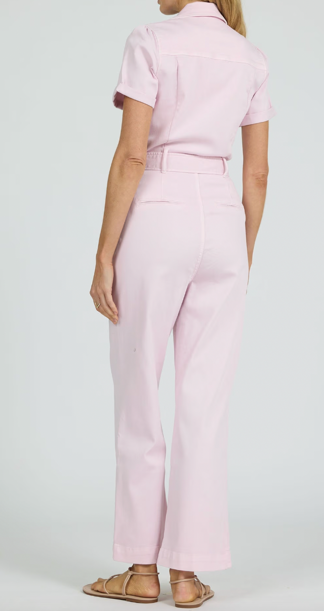 Person wearing a light pink outfit with a white background