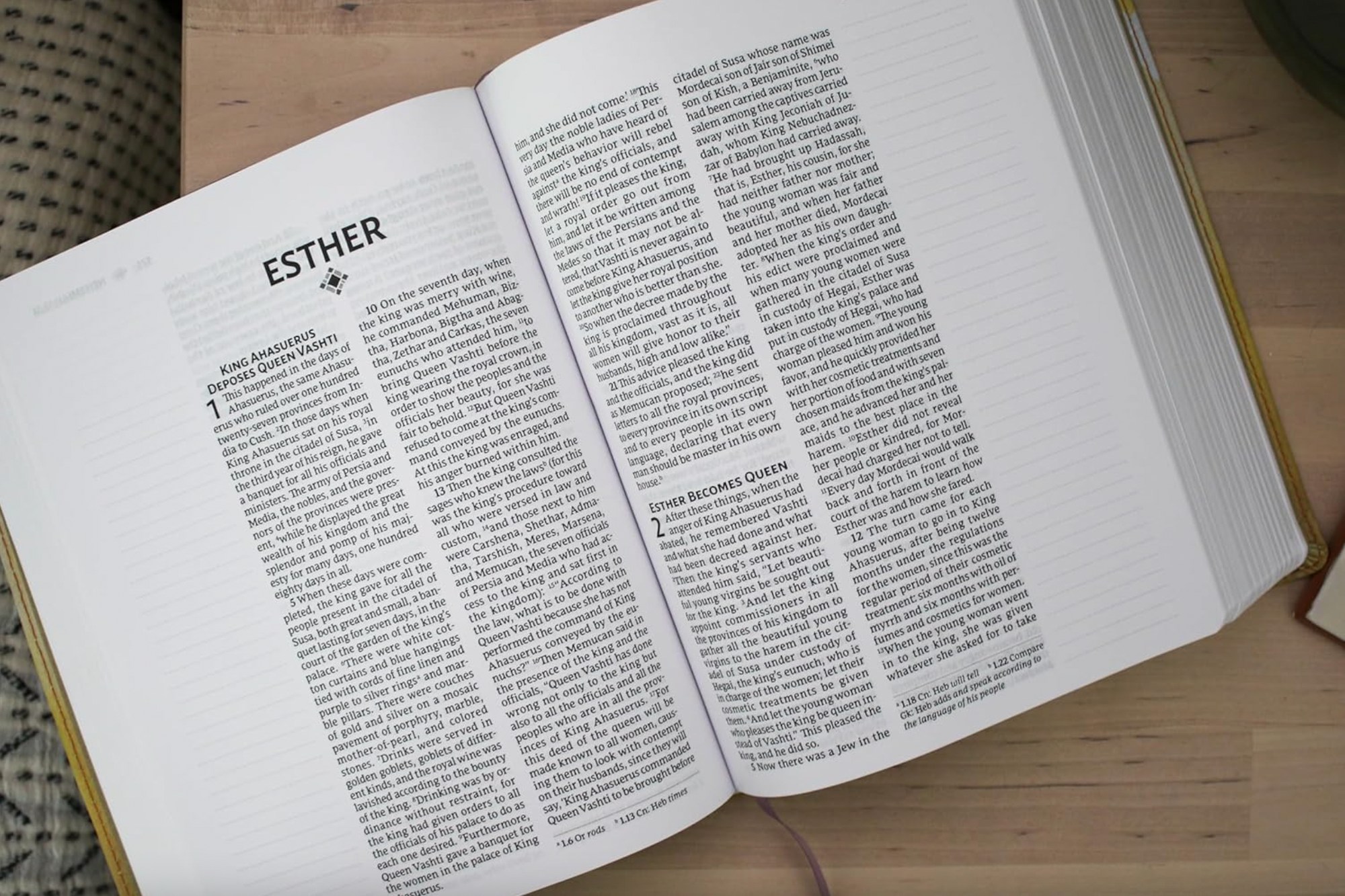 Open book with 'Esther' chapter on a wooden surface